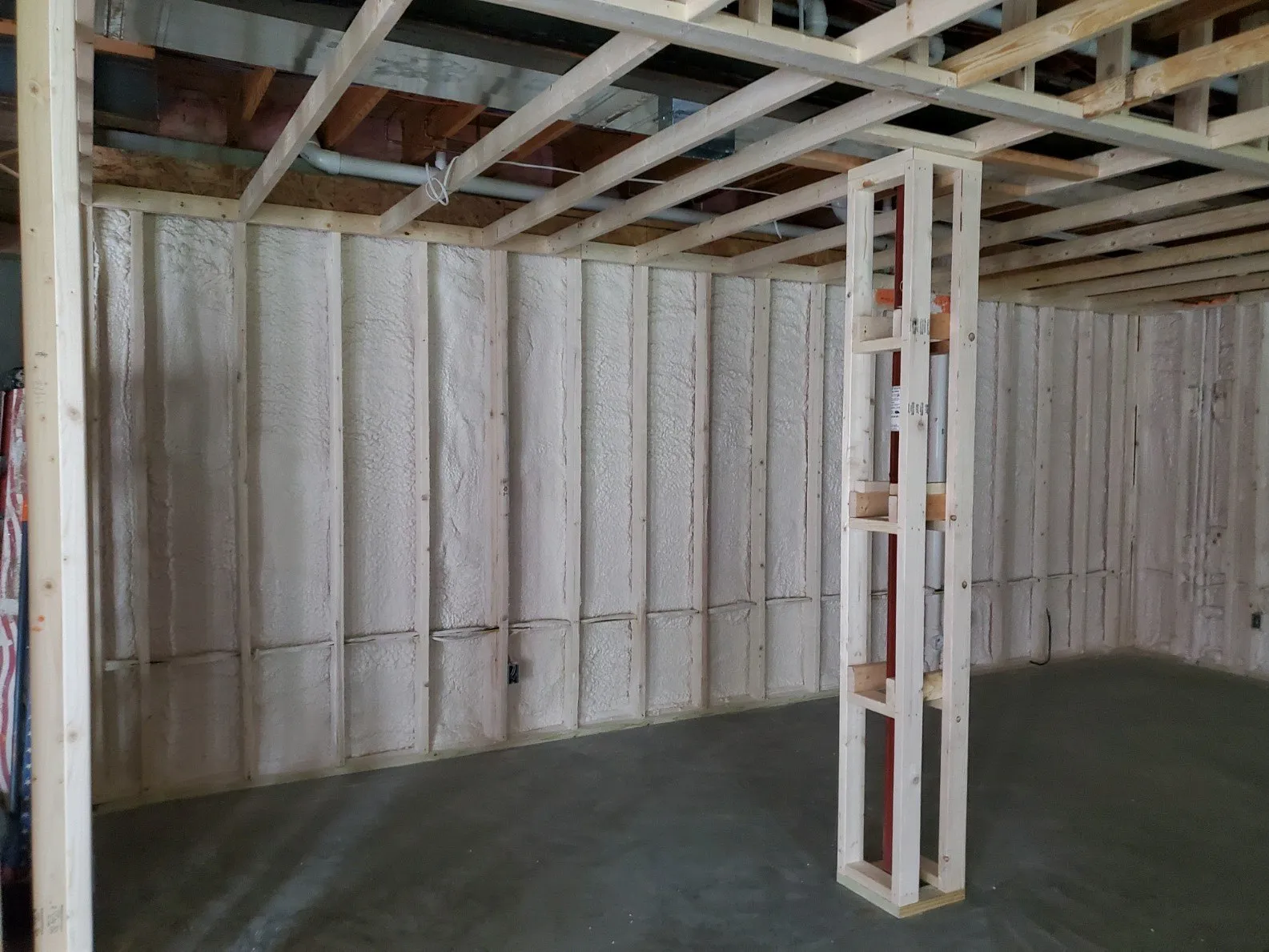 Spray foam insulation around pipes and attic penetrations