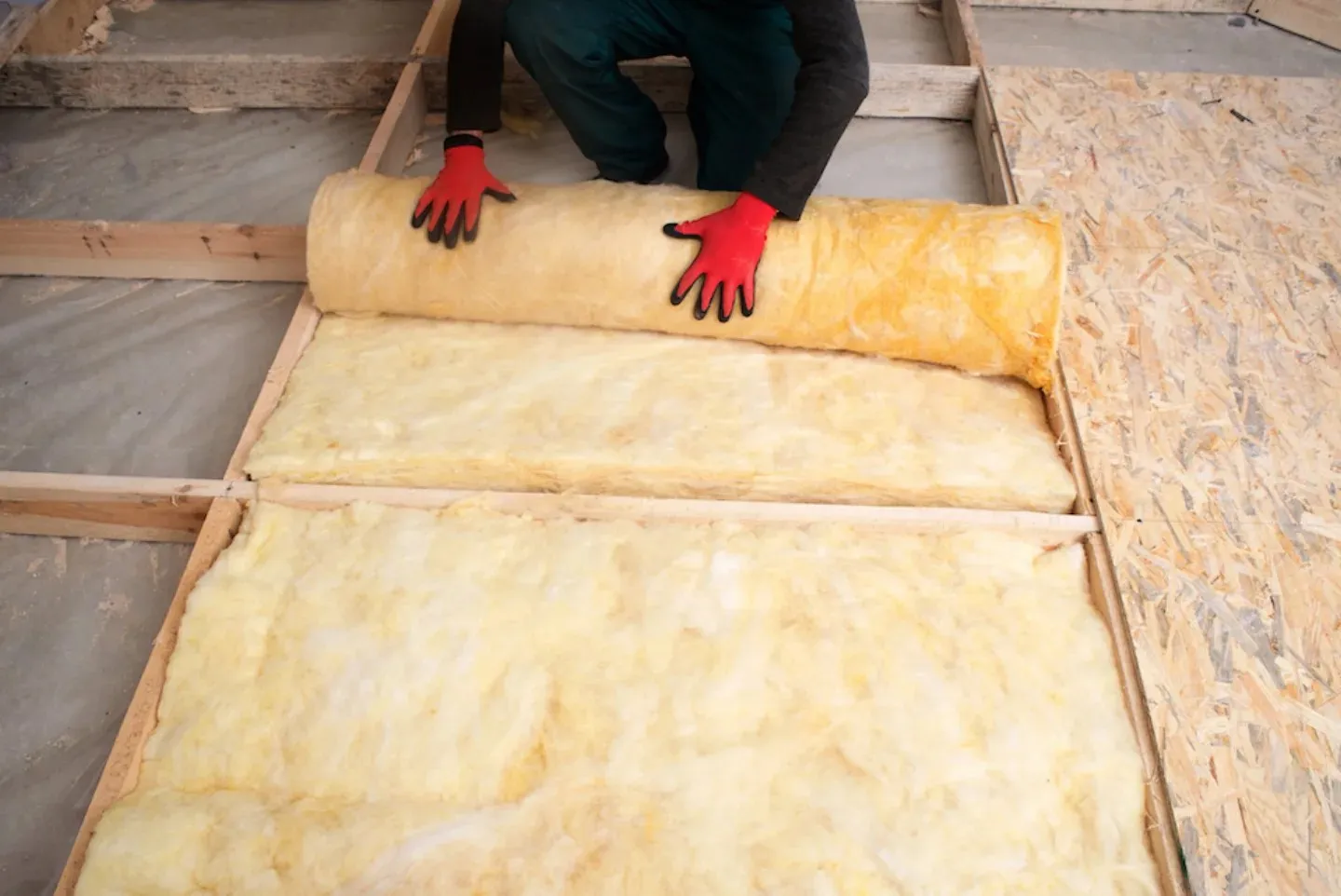 Fiberglass insulation being prepared in a framed assembly